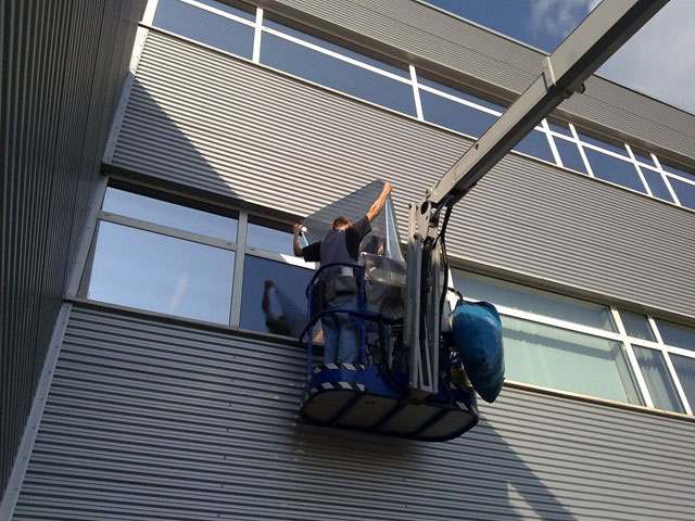 Die Montage von Folie auf eine Senkrechtverglasung bei IEE-Luxemburg